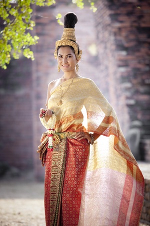 Asian woman dressed in traditional Thai clothing posingの写真素材