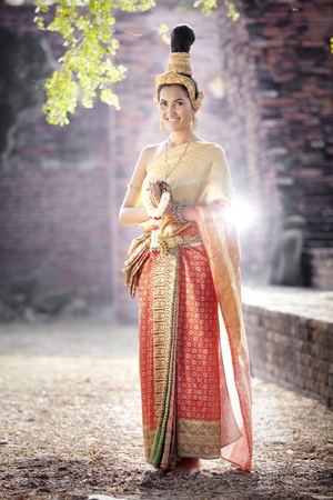 Asian woman dressed in traditional Thai clothing posing