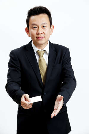 Businessman holding a blank business card isolated on white backgroundの写真素材