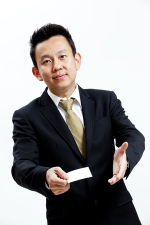 Businessman holding a blank business card isolated on white backgroundの写真素材