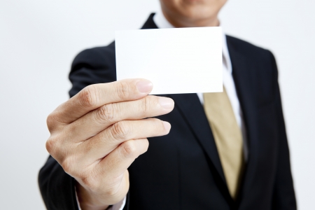 Businessman holding a blank business card with isolated on white backgroundの写真素材