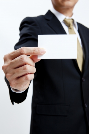 Businessman holding a blank business card isolated on white backgroundの写真素材