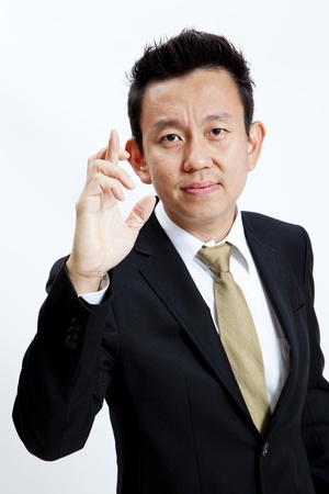 Businessman with crossed fingers isolated on white backgroundの写真素材
