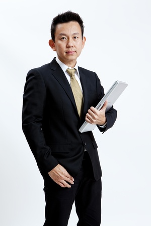 Businessman standing with laptop isolated on white backgroundの写真素材