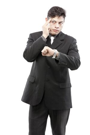Businessman is thinking after checking time from his watchの写真素材