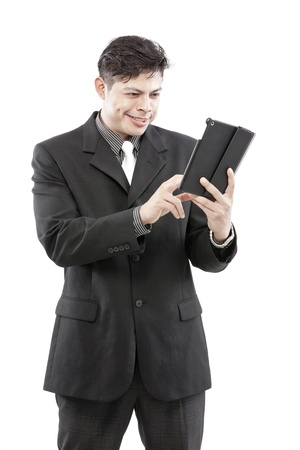 Businessman points at tablet and give the expression of his face  の写真素材