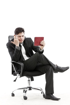Businessman holding tablet and give the expression of his faceの写真素材