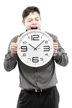 Businessman holding big clock and give the expression on his face の写真素材