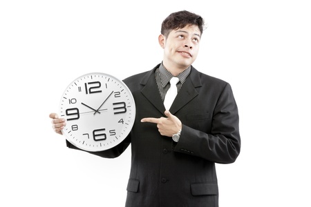 Portrait of a businessman holding a clock against white backgroundの写真素材