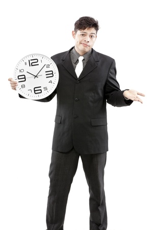 Businessman standing and express his emotions while holding the clock in his handの写真素材