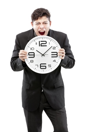 Businessman holding big clock and give the expression on his face の写真素材