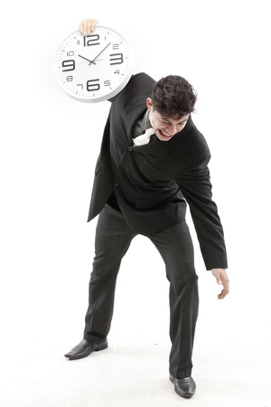 Portrait of a businessman posing with a clockの写真素材