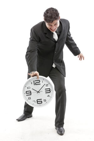 Portrait of a businessman posing with a clock の写真素材