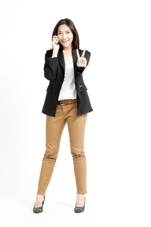 Young business woman on the phone isolated on white backgroundの写真素材