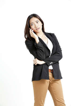 Young business woman on the phone isolated on white backgroundの写真素材