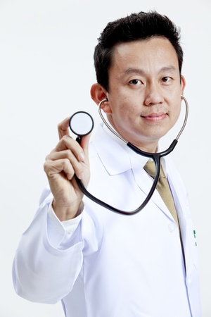 Doctor holding up a stethoscope isolated on white backgroundの写真素材