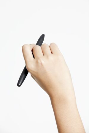Female hand with pen against white backgroundの写真素材