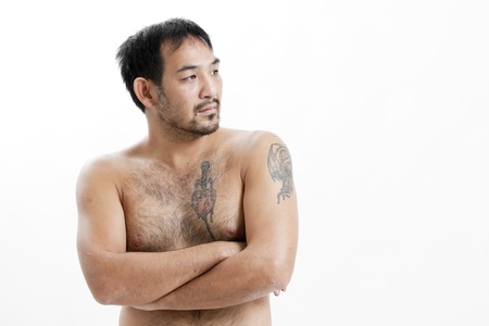 Shirtless Asian man with tattoosの写真素材