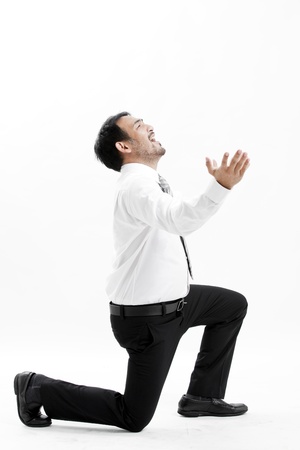 Businessman kneeling and expressing frustrationの写真素材