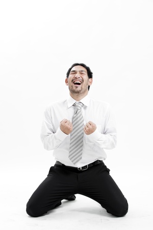 Businessman on knees beggingの写真素材