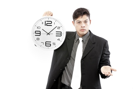 Businessman standing and holding a clockの写真素材