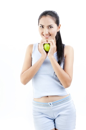 Beautiful asian lady holding a green apple の写真素材