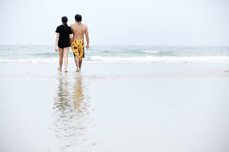 Couple walking on beachの写真素材