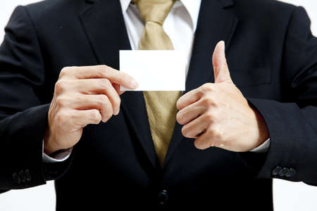 Close up of businessman holding a blank business cardの写真素材