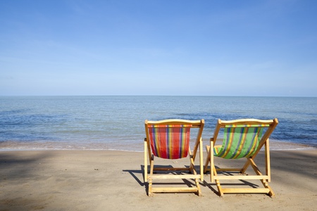 Two deck chairs beside the beach on a sunny dayの写真素材