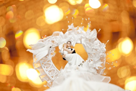 Close up of ride and groom on top of a wedding cakeの写真素材