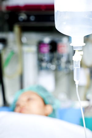 Close up of IV bag with patient in the backgroundの写真素材