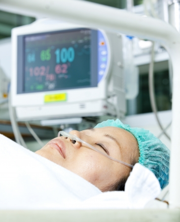 Patient with oxygen tube lying on a gurneyの写真素材