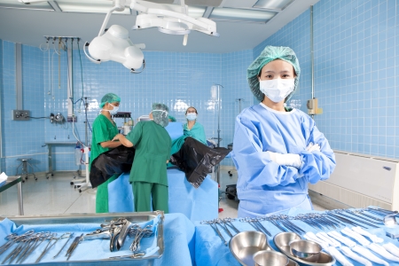 Surgeons and nurses in an operating roomの写真素材