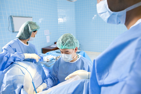 Surgeons operating on a patientの写真素材