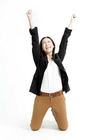 Pretty Asian woman in jacket and khakis overjoyedの写真素材
