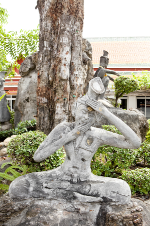 Ancient Thai statue posing outside of the Thai templeのeditorial素材