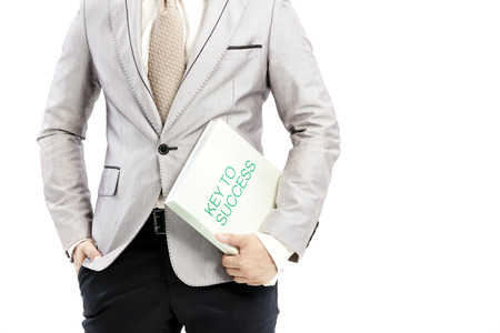 Businessman is holding a motivational bookの写真素材