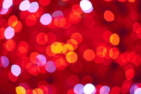 Heart shape bokeh on red backgroundの写真素材