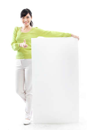 Young woman holding a blank white boardの写真素材