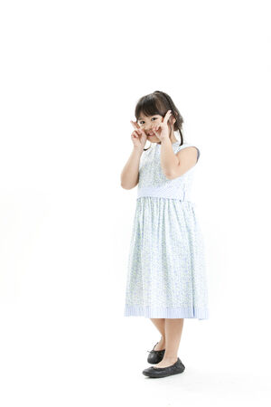 Girl posing in a floral dress while gesturingの写真素材