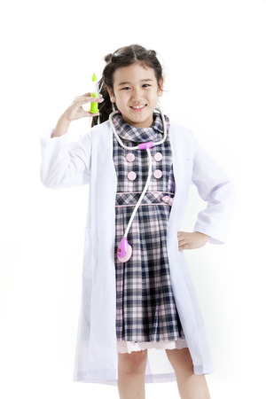 Girl posing in a checkered dress and lab coatの写真素材