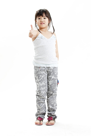 Girl posing for the camera with hand gestureの写真素材