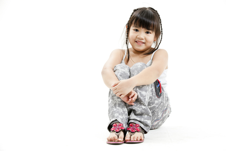 Girl sitting and posing for the cameraの写真素材