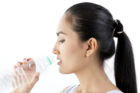 Asian woman with a bottle of waterの写真素材