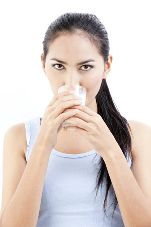 Asian woman drinking a glass of milkの写真素材