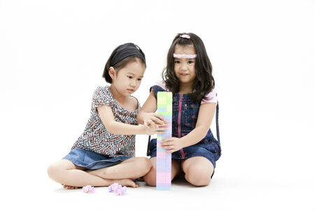 Girls sitting on the floor playing with toysの写真素材