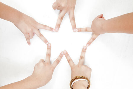 Joining of fingers to create a star shape on white backgroundの写真素材