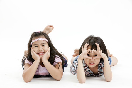 Girls posing while lying down on the floorの写真素材
