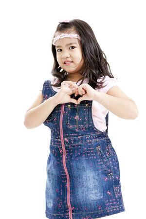 Girl posing in casual clothings while gesturing a heartの写真素材