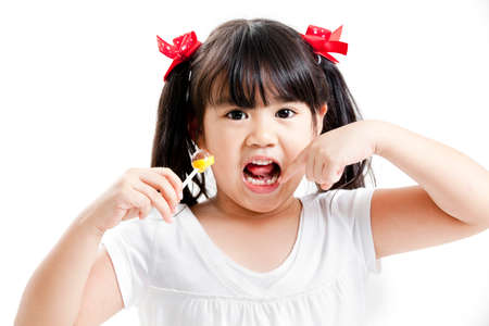 Girl posing with lollipop on white background